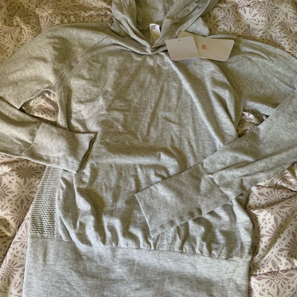 New with tags Super cute light grey Fabletics long sleeve top w/ hoodie size: S